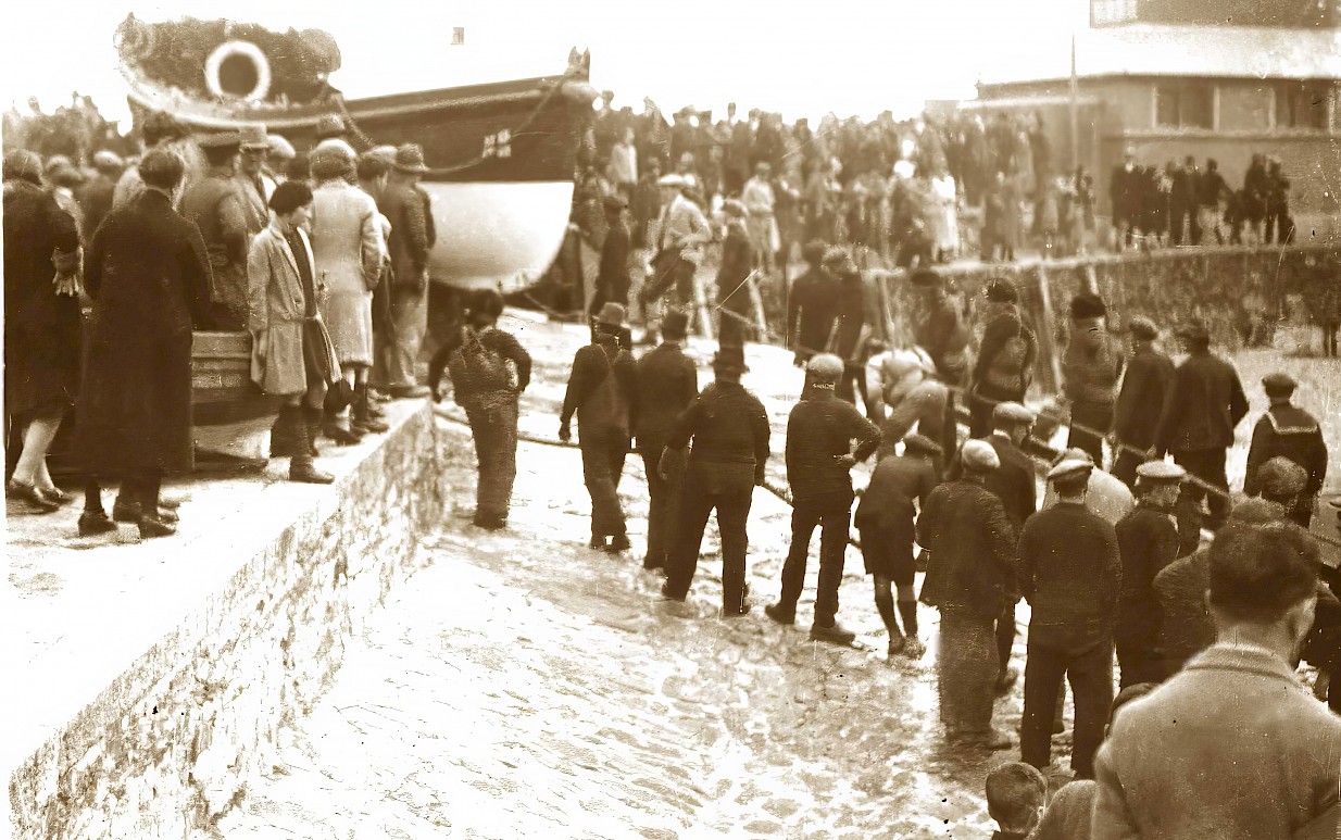 A crowd gathers to watch Ryder launched on the slipway